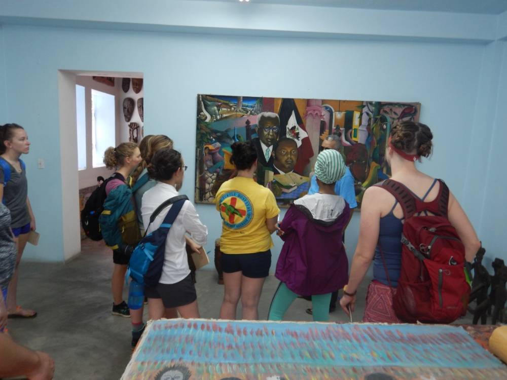 Examining artwork at El-Saieh Gallery in Petionville, Haiti
